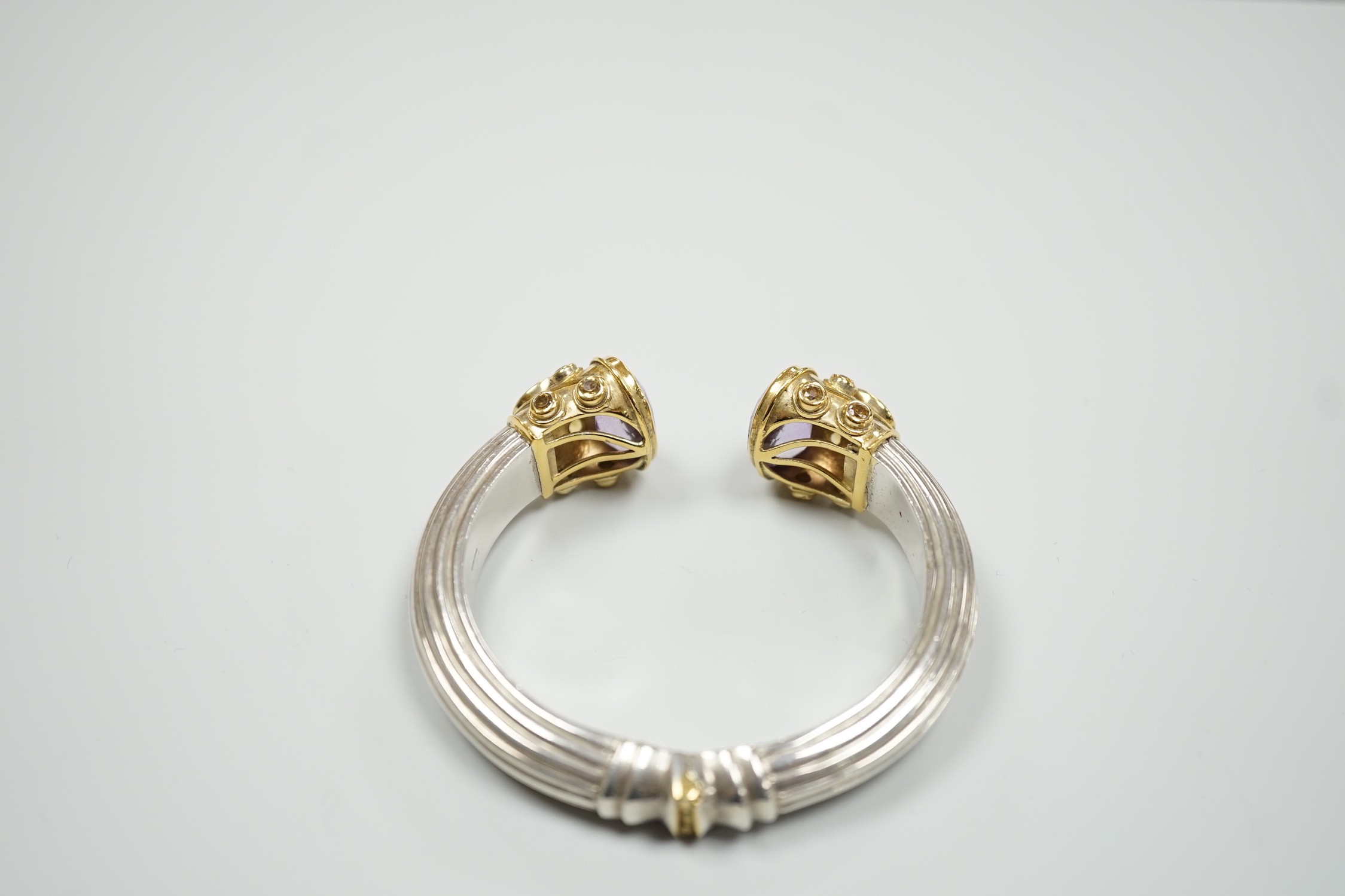 A modern parcel gilt silver amethyst and citrine set openwork spring hinged bangle.